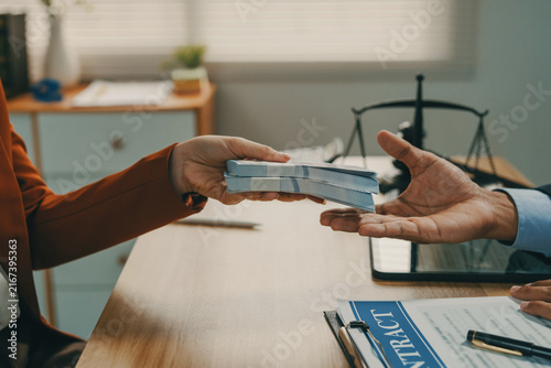 Fotografie Person accepting money, representing bribery or corruption