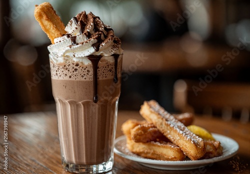 Iced Chocolate Frappe with Whipped Cream and Churros in Cafe