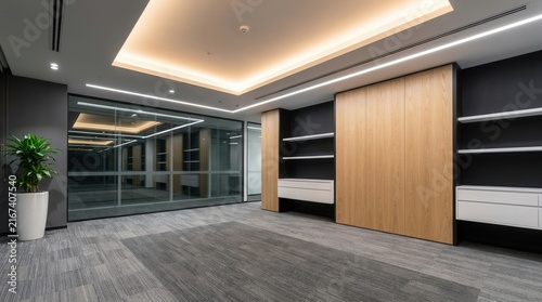 Glass walls, wooden panels, and carpet flooring in a modern empty office interior space.