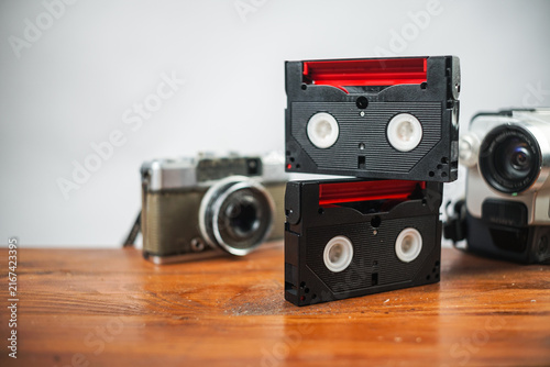 Vintage cassette tapes and camera on wooden desk