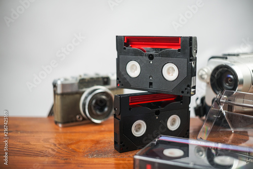 Vintage cassette tapes and camera on wooden desk