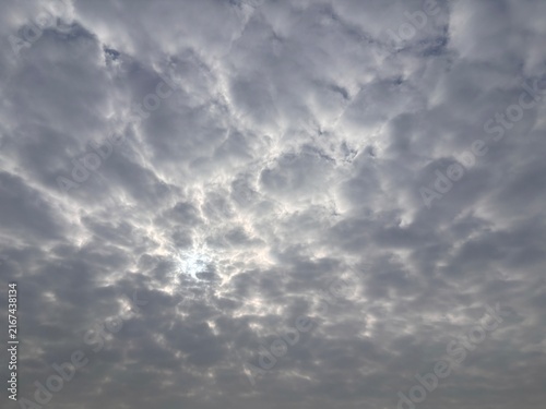 Dramatic dramatic cloudy sky with thick grey layers and sunlight filtering through. Natural weather background for meteorological and atmospheric concepts.