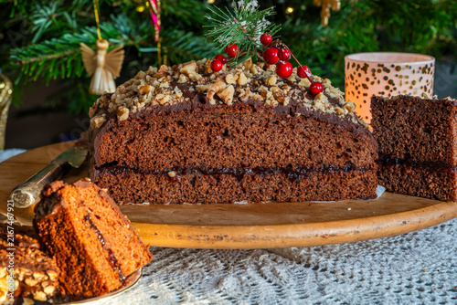 Homemade ginger cake with plum marmalade, pecan nuts and chocolate ganache