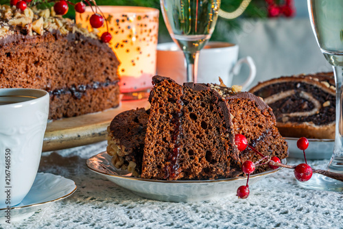 Homemade ginger cake with plum marmalade, pecan nuts and chocolate ganache