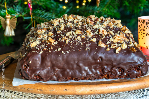 Homemade ginger cake with plum marmalade, pecan nuts and chocolate ganache