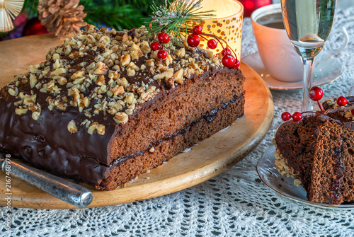 Homemade ginger cake with plum marmalade, pecan nuts and chocolate ganache