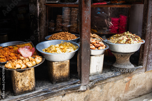 Fotografie Four large bowls of street food in a poor section of Varanasi India on a porch stoop