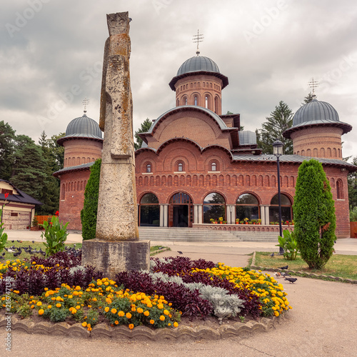 Cathedral and stone monument in the gardens of Curtea de Arges Monastery, Arges County, Romania