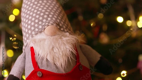 Cute Christmas Gnome Doll Against Blurry Holiday Lights Background
