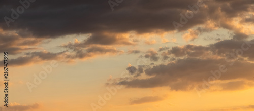 Konstfotografi Panoramic evening sky with scattered clouds during warm sunset