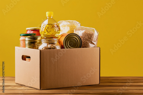  cardboard donation box overflowing with non-perishable food items, 