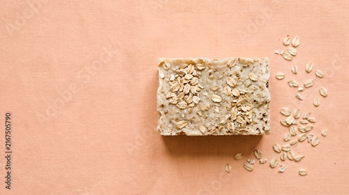 Natural handmade oatmeal soap bar, organic exfoliating oat body scrub, artisanal vegan skincare product on peach background isolated PNG with Transparent Background