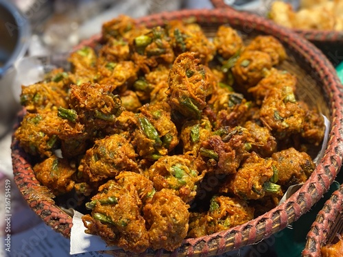 Crispy Vegetable Onion Pakoras or Piyaju Fritters in Basket