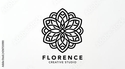 фотографія A black and white floral emblem logo for a creative studio on a white background