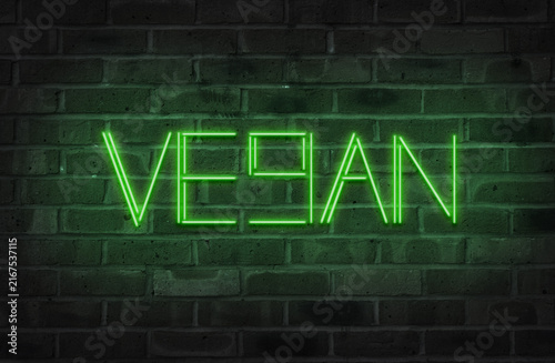 Neon Vegan sign on a brick wall