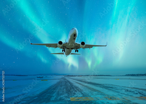 Принти на полотні Commercical white airplane fly up over take-off runway the (ice) snow-covered ai