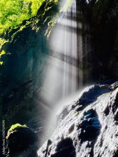 Breathtaking Partnachklamm Gorge in the Bavarian Alps, Germany, featuring dramatic limestone cliffs, crystal-clear rushing water, and lush green vegetation. 