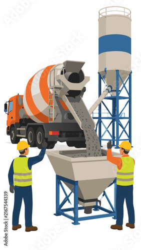 Two construction workers in hard hats and high-visibility vests directing a concrete mixer truck pouring fresh cement into an industrial hopper with a tall storage silo in the background