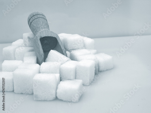Картината върху платно White sugar cubes in a small wooden scoop for sweetening