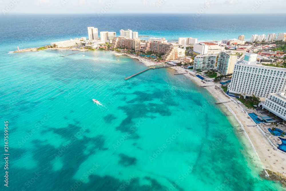Fototapeta premium Aerial panoramic view of Cancun beach and city hotel zone in Mexico. Caribbean coast landscape of Mexican resort with beach Playa Caracol and Kukulcan road. Riviera Maya in Quintana roo region on