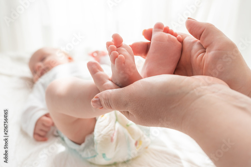 Konstfotografi Mother cherishes the delicate feet of her child, Concept of maternal love and te