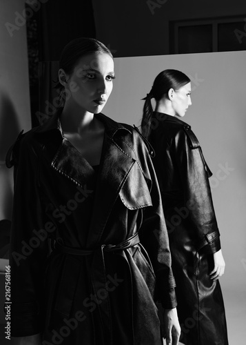 Fotografie Lovely young woman standing in front of the mirror