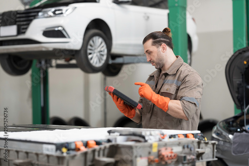 EV car repair  maintenance  inspecting services. Mechanic diagnosing battery pack  component checks  electric car vehicles battery  electric car software update  testing and install at auto workshop