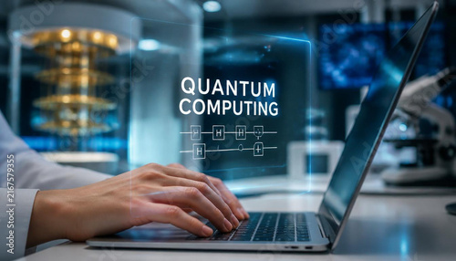 Dedicated researcher typing on laptop with blue holographic quantum computing interface in modern science laboratory environment