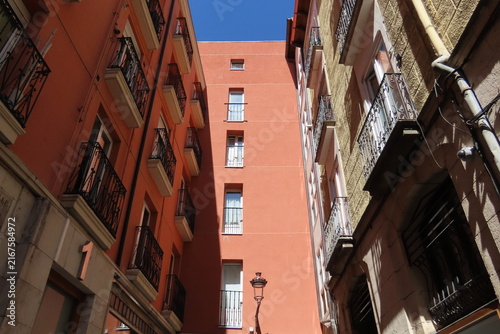 Narrow Alley Between Old Buildings with Balconies in Historic Center