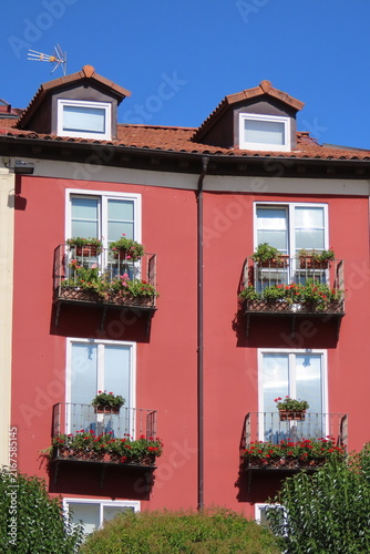 Pink Residential Building Facade with Flowered Balconies