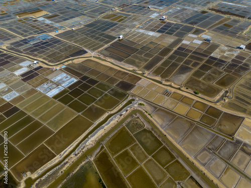 Obraz na plátně Aerial view of traditional salt fields, showcasing a vast geometric landscape of salt ponds and evaporation basins
