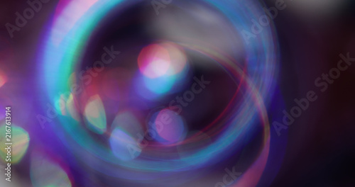Bokeh light. Colorful glitter texture. Vibrant pink blue green lens flare bright optical glisten reflection on abstract illuminated background.