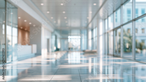 Elegent photo of Blurred interior view of a modern glass office building lobby with bright natural lighting. Ideal background for corporate business presentations and.