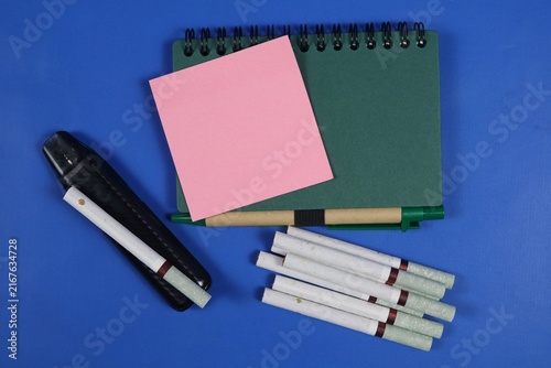 Canvastavla Smoking and vaping health awareness concept with cigarettes, vape device, notebook, and pink note on an dark blue background, featuring copy space for text