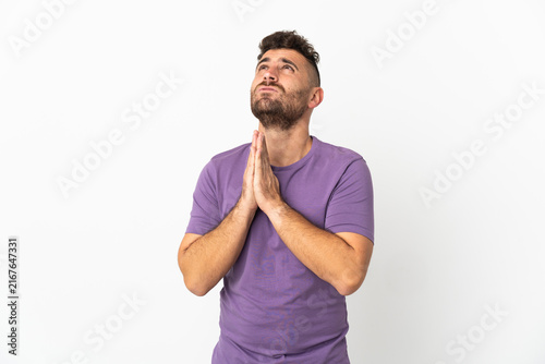 Canvastavla Caucasian man isolated on white background keeps palm together