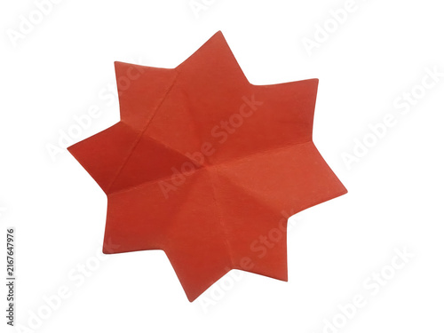 Foto Red paper star shape folded from a square sheet of craft paper isolated on trans