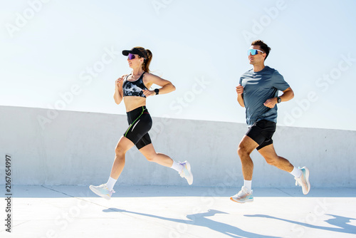Active runners enjoying a sunny workout on a rooftop during a clear day