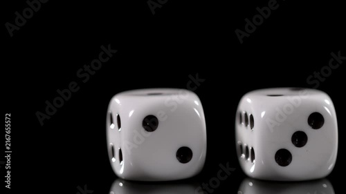 Slow motion of dice rolling and landing with detailed movement and cinematic motion