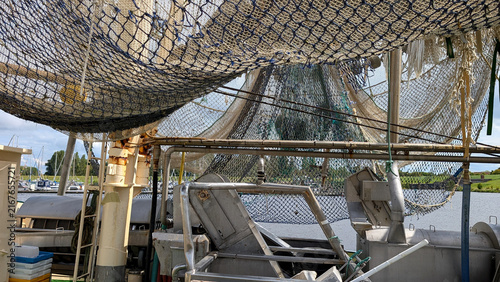 Quadro su tela Deck machinery beneath fishing nets on a shrimp trawler.