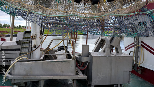 фотографія Shrimp trawler deck with fishing nets and processing equipment.