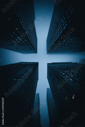 cityscape view from the bottom of streets looking up, four dark skyscrapers forming a symmetrical cross, portrait view, photorealistic