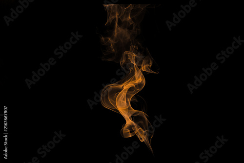 Fotografía Orange smoke swirl on black background, ethereal fire vapor trail, mystical gold