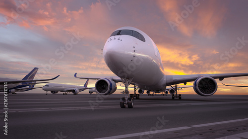 Large passenger airplane parked on a tarmac at sunset, with aircraft behind, visible engines, runway markings, and pink sky.