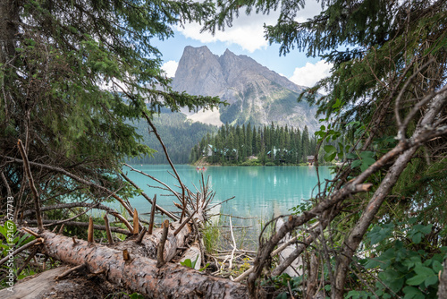 Emerald Lake in Yoho National Park, Canada, with vivid turquoise water framed by dense forest and dramatic Rocky Mountains on a summer day.