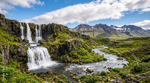 Majestic mountain scenery featuring powerful waterfall and winding hiking trail