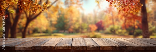 Wooden table with a tablecloth set against a backdrop of autumn foliage in a natural setting