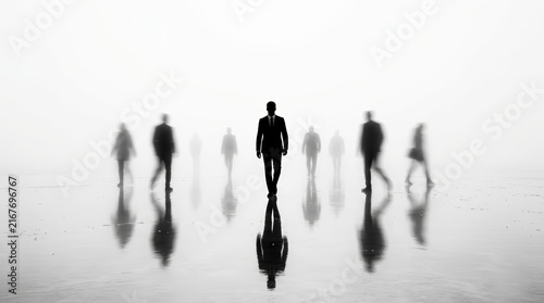 An abstract business concept featuring silhouettes of people walking in the fog.