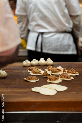 Steamed Bun Preparation At Restaurant Counter Background Blur