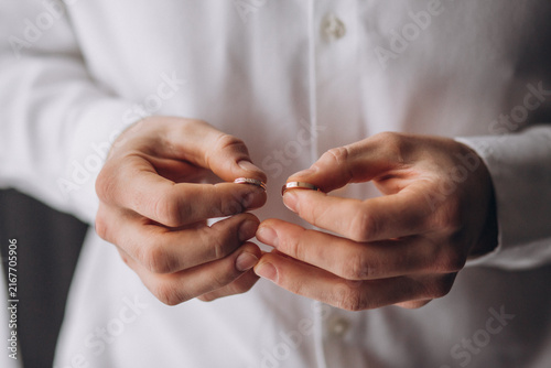 Foto Broken Promise: A person holds two halves of a broken wedding ring, symbolizing heartbreak and the end of a marital union