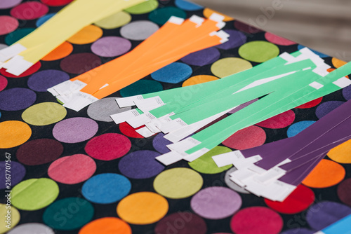 Canvastavla Colorful Paper Strips on Polka Dot Background: Vibrant strips of colored paper are neatly arranged on a lively polka dot fabric, hinting at creativity and craft